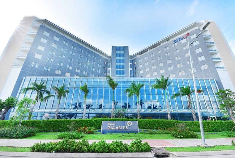 Exterior view of Gia An 115 Hospital in Vietnam, featuring a modern building with glass facade and landscaping.